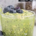 Bowl of matcha overnight oats topped with fresh fruits and nuts