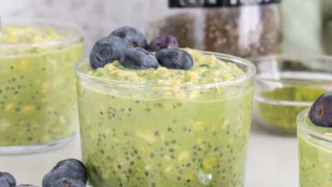 Bowl of matcha overnight oats topped with fresh fruits and nuts