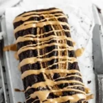 Delicious peanut butter chocolate banana bread slices on a wooden table.