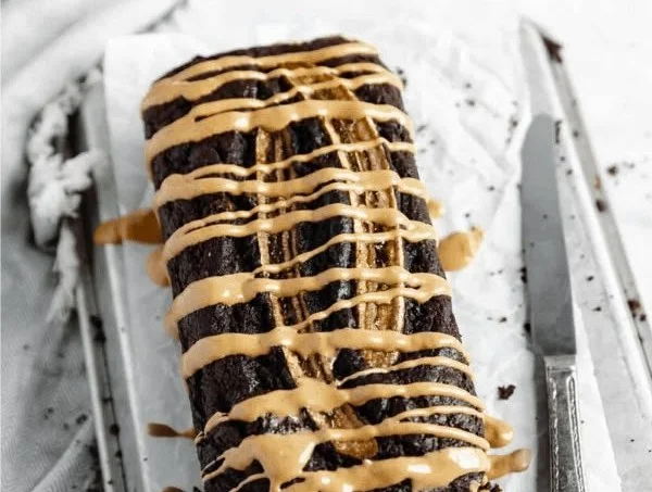 Delicious peanut butter chocolate banana bread slices on a wooden table.