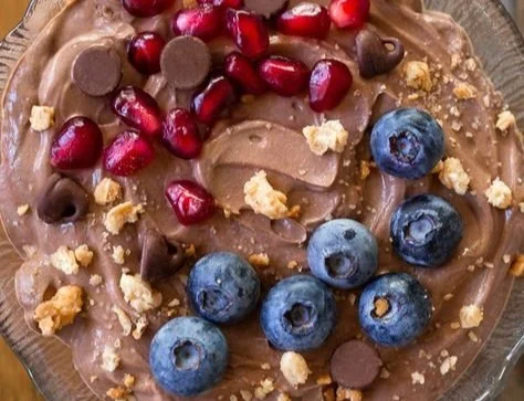 A bowl of Protein Fluff topped with fruits, showcasing a healthy dessert option.