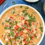 Slow cooker chicken served with vegetables and herbs in a bowl