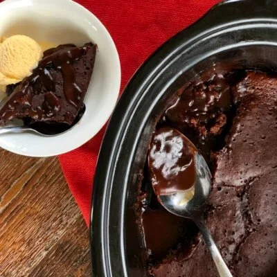 Delicious slow cooker chocolate self-saucing pudding topped with whipped cream.
