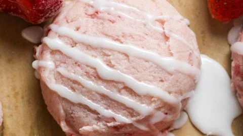 Delicious and fresh strawberry cookies on a plate decorated with mint leaves