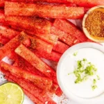 Tajin-coated spicy watermelon fries served on a plate