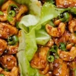 Delicious tofu lettuce wraps with fresh vegetables and sauce on a plate.