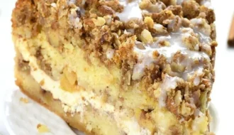 Delicious apple coffee cake with cream cheese filling on a wooden table