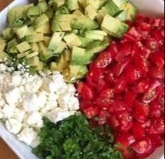 Creamy Avocado Crack Dip garnished and served with tortilla chips