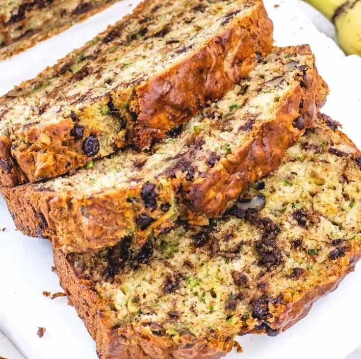 Delicious banana zucchini bread sliced on a wooden board