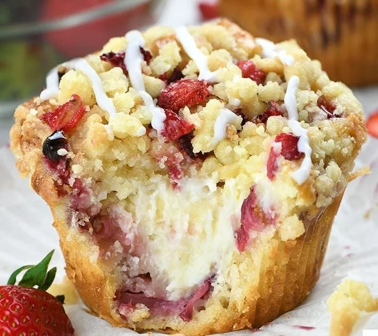 Delicious strawberry cream cheese muffins topped with fresh strawberries