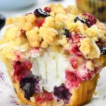 Delicious summer berry cream cheese muffins on a wooden table