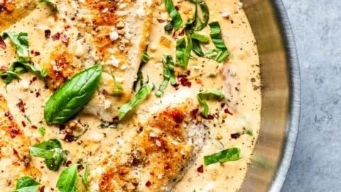 Creamy Parmesan Basil Chicken served on a plate garnished with fresh basil