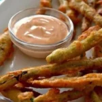 Crispy fried green beans served with a side of sriracha mayo.