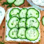 Plate of refreshing cucumber sandwiches ready to serve at a tea party.