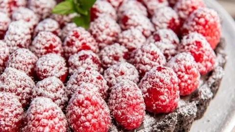 Delicious easy chocolate raspberry tart topped with fresh raspberries