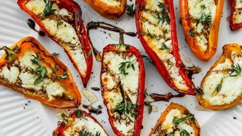 Delicious goat cheese stuffed mini peppers served on a platter