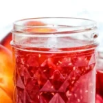 Homemade easy raspberry peach jam in a glass jar
