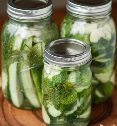 Easy homemade refrigerator dill pickles recipe in a jar with fresh herbs