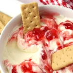 Delicious easy strawberry cheesecake dip served in a bowl