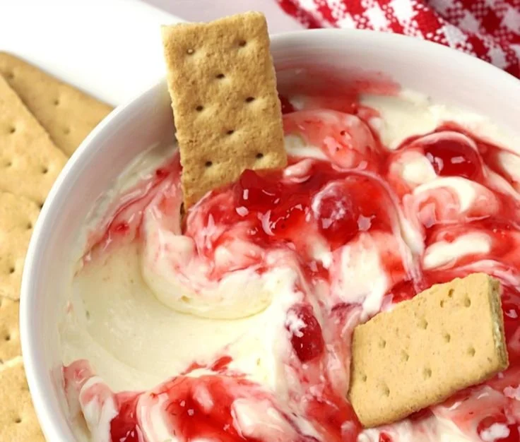 Delicious easy strawberry cheesecake dip served in a bowl with fresh strawberries