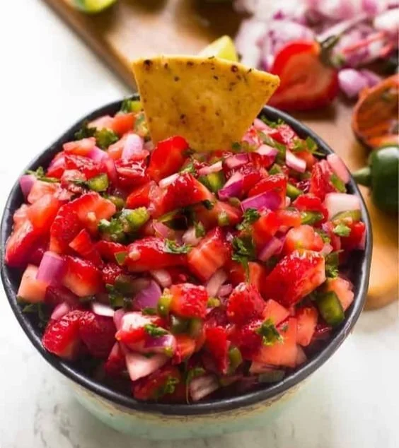 Bowl of easy strawberry jalapeño salsa with fresh ingredients