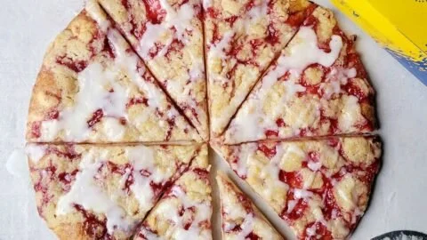 Gluten-free raspberry crumble dessert pizza topped with fresh raspberries