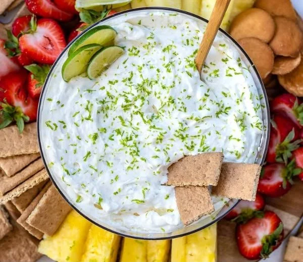 Easy Key Lime Pie fruit dip recipe served in a bowl with lime garnishes.