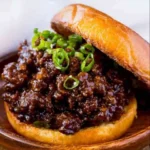 Delicious Korean Beef Sloppy Joes served on a bun with toppings