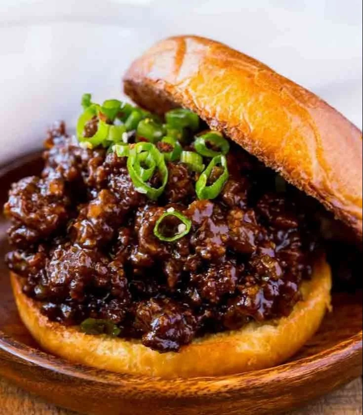 Delicious Korean Beef Sloppy Joes served on a bun with toppings