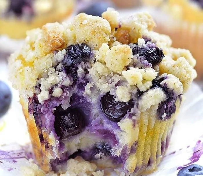 Freshly baked lemon blueberry muffins on a cooling rack