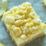 Delicious lemon sugar cookie bars on a white plate.
