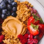 Delicious Peanut Butter Acai Bowl topped with fresh fruits and granola