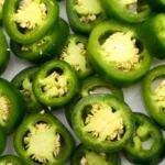 Jars of homemade Pineapple Jalapeño Pickles with vibrant ingredients
