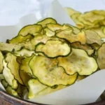 Bowl of crispy salt and vinegar zucchini chips ready to snack on
