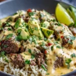 Delicious Steak Queso Rice served in a bowl with melted cheese and steak chunks