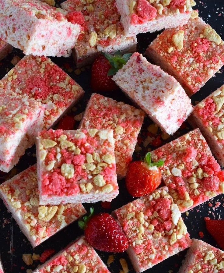 Strawberry Shortcake Rice Krispie Treats displayed on a plate with fresh strawberries