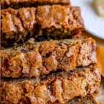 Deliciously moist homemade zucchini bread on a wooden cutting board.