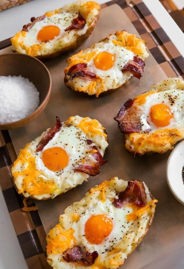 Twice baked loaded breakfast potatoes topped with cheese and bacon