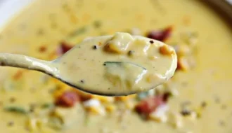 Bowl of creamy Zucchini Corn Chowder with fresh corn and zucchini chunks