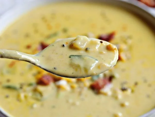 Bowl of creamy Zucchini Corn Chowder with fresh corn and zucchini chunks