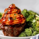 BBQ Meatloaf Muffins topped with sweet potato served on a plate