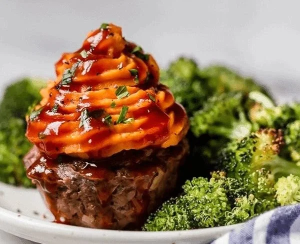 BBQ Meatloaf Muffins topped with sweet potato served on a plate