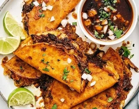 Delicious Beef Birria Tacos garnished with fresh toppings