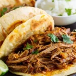 Delicious slow cooker carnitas served on tacos with toppings
