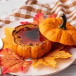 Mini pumpkin filled with creamy pumpkin creme brulee for a seasonal dessert