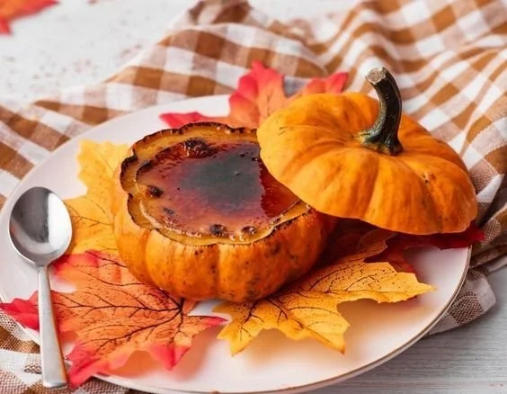 Mini pumpkin filled with creamy pumpkin creme brulee for a seasonal dessert