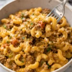 Delicious slow cooker hamburger helper served in a bowl with toppings.