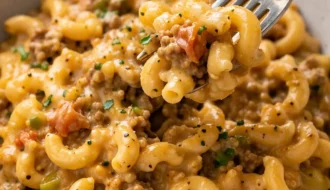 Delicious slow cooker hamburger helper served in a bowl with toppings.