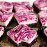 Delicious homemade blackberry cheesecake brownies with creamy cheesecake layer