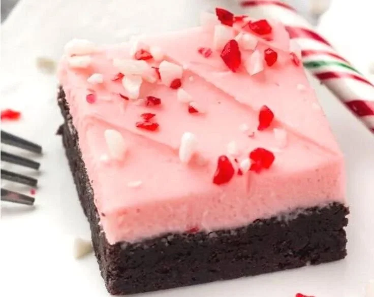 Delicious candy cane brownies topped with crushed candy canes for a festive treat.